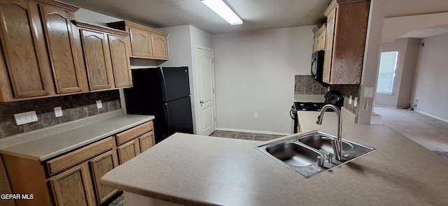 kitchen with backsplash, light colored carpet, sink, and black appliances