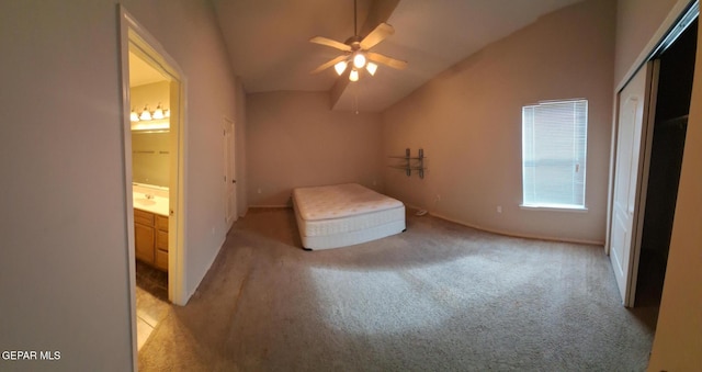 unfurnished bedroom featuring light colored carpet, lofted ceiling, ceiling fan, and connected bathroom