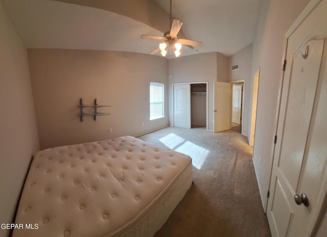 unfurnished bedroom with light carpet, ceiling fan, and vaulted ceiling