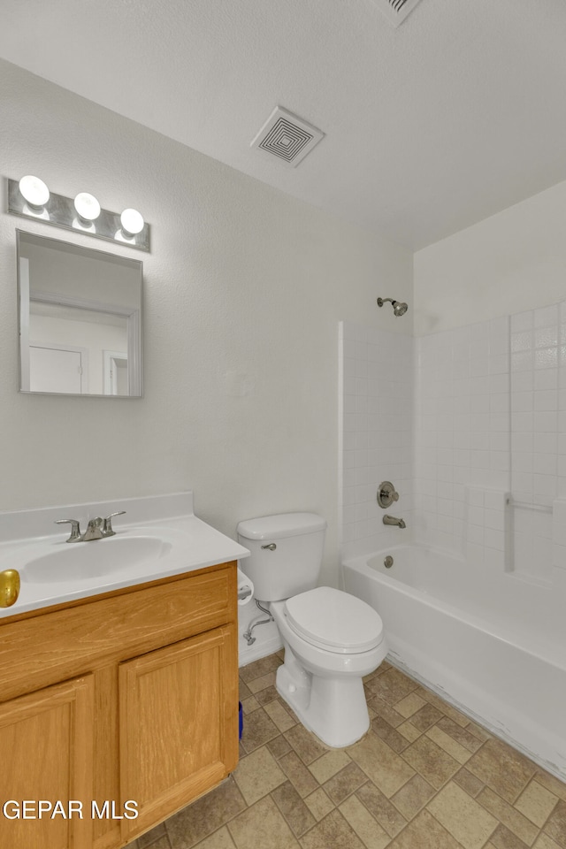 full bathroom with vanity, toilet, and tiled shower / bath