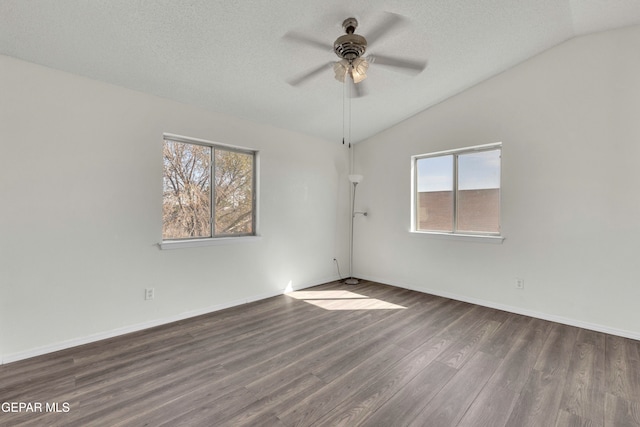 empty room featuring dark wood-type flooring, ceiling fan, a textured ceiling, and lofted ceiling