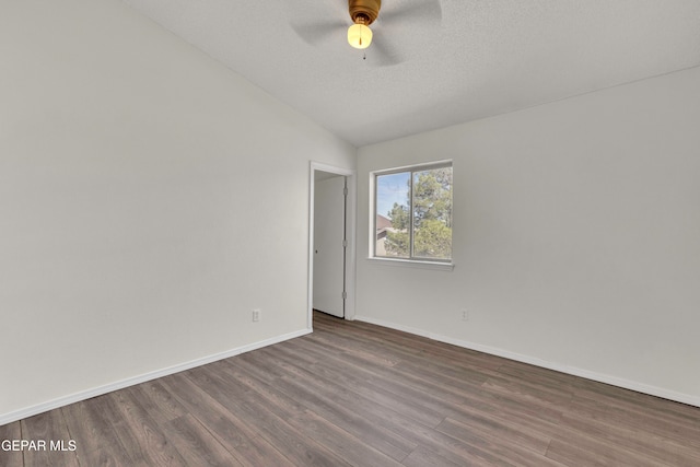 spare room with lofted ceiling, a textured ceiling, hardwood / wood-style flooring, and ceiling fan