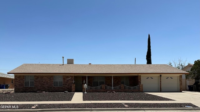 ranch-style home with a porch and a garage