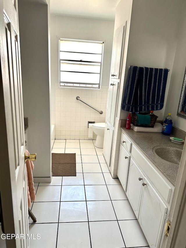 full bathroom featuring vanity, toilet, tile walls, and tile patterned flooring