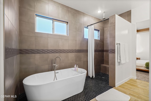 2300 Tierra Zaria, El Paso, TX 79938 - bathroom featuring tiled shower, a freestanding tub, wood finished floors, tile walls, and ensuite bath