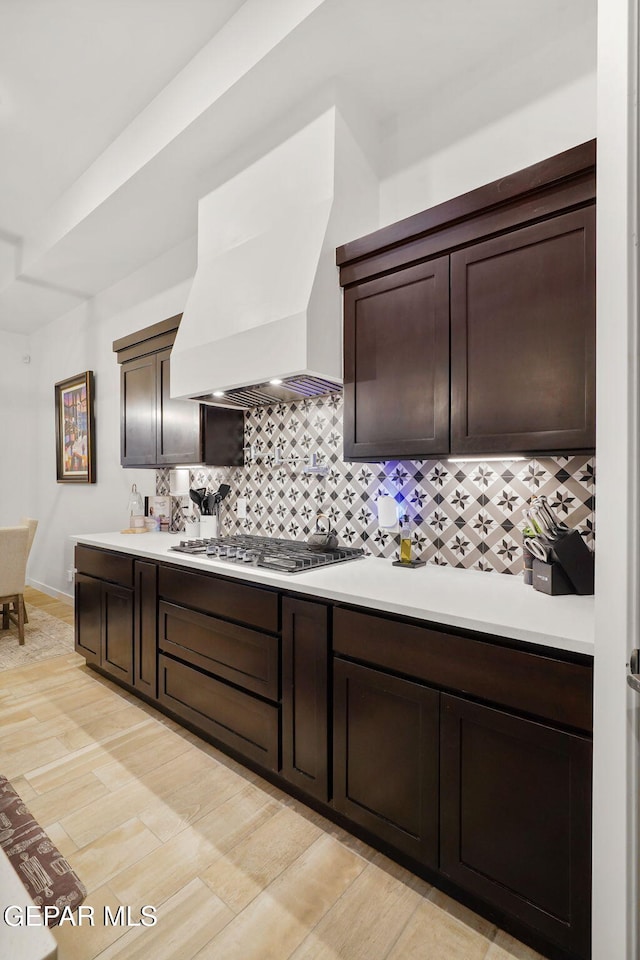 2300 Tierra Zaria, El Paso, TX 79938 - kitchen featuring wall chimney exhaust hood, backsplash, light countertops, and stainless steel gas stovetop