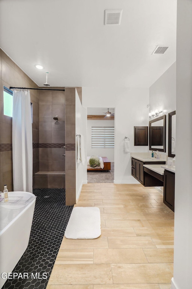 2300 Tierra Zaria, El Paso, TX 79938 - full bath featuring a walk in shower, vanity, a freestanding tub, and wood finished floors