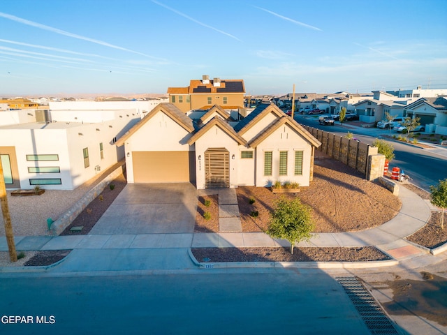2300 Tierra Zaria, El Paso, TX 79938 - view of front facade with a residential view, stucco siding, solar panels, and concrete driveway