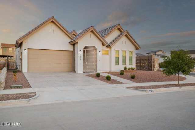 2300 Tierra Zaria, El Paso, TX 79938 - view of front of house featuring stucco siding, concrete driveway, a garage, and a tile roof