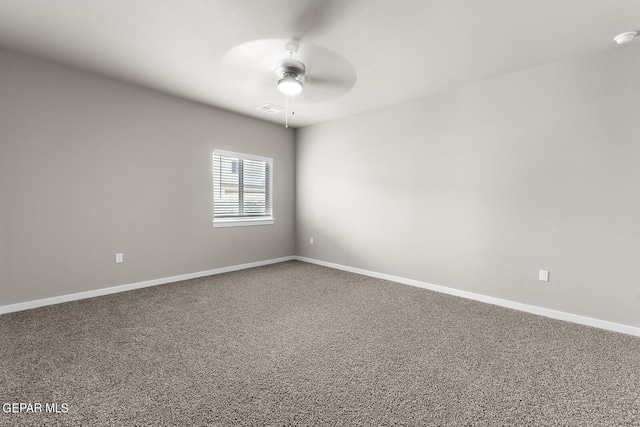 carpeted spare room featuring ceiling fan