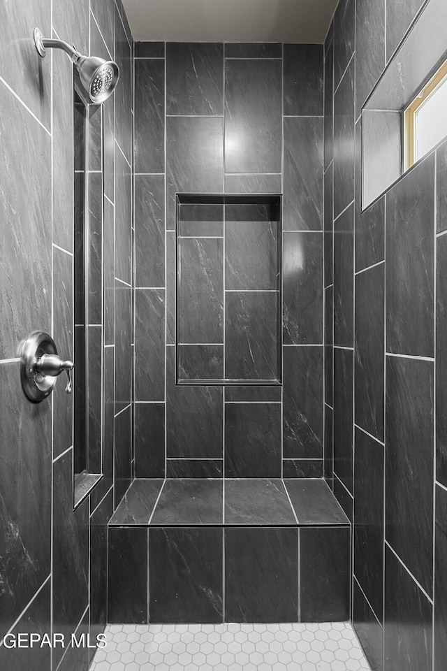 bathroom with tiled shower