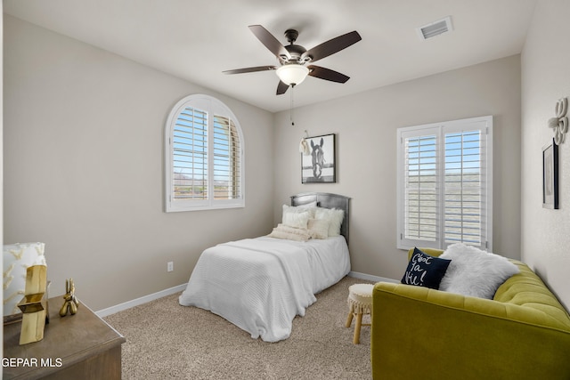 bedroom with carpet flooring, multiple windows, and ceiling fan