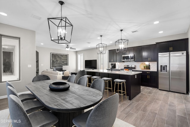 dining area featuring light hardwood / wood-style flooring and ceiling fan