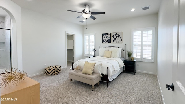 5844 Kobe Bryant St, El Paso, TX 79924 - bedroom featuring light carpet, multiple windows, arched walkways, baseboards, and recessed lighting