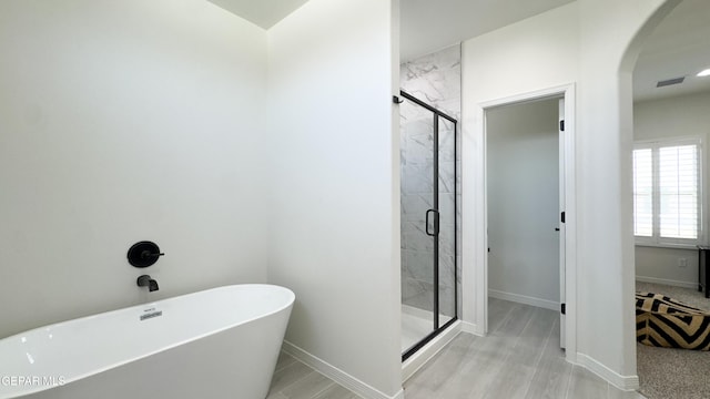 5844 Kobe Bryant St, El Paso, TX 79924 - full bath with a freestanding tub, a stall shower, and baseboards