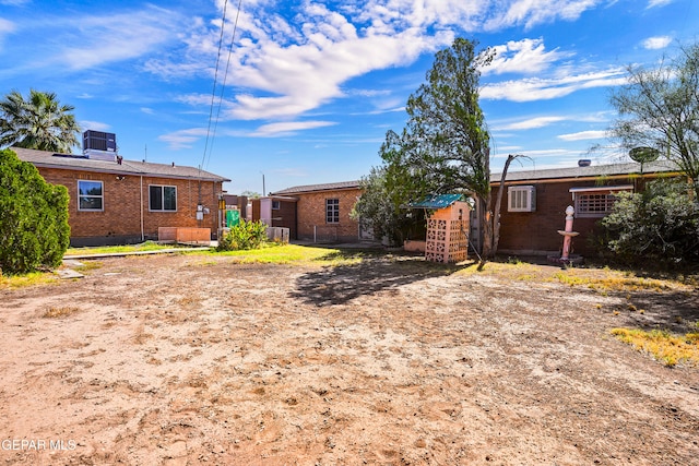 rear view of property featuring central AC unit