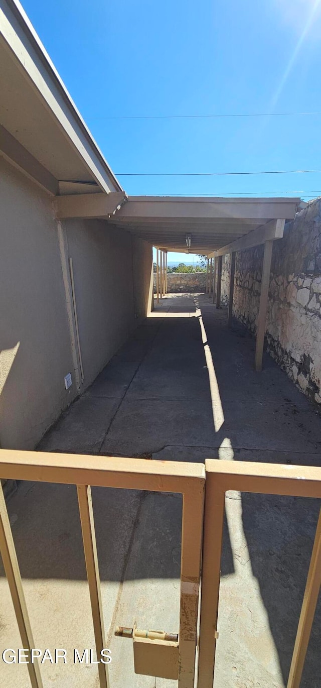 view of car parking with a carport and fence