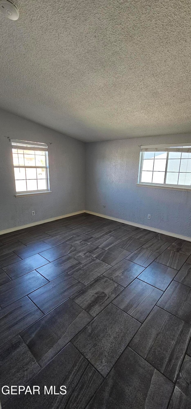 empty room featuring a textured ceiling