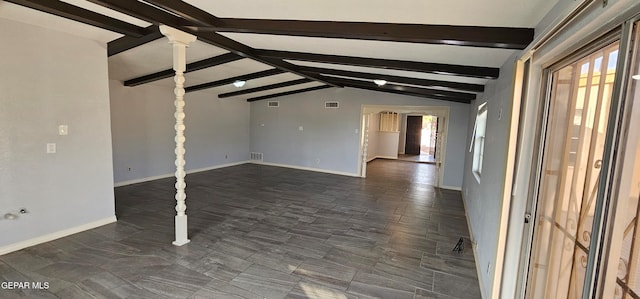 unfurnished living room featuring lofted ceiling with beams