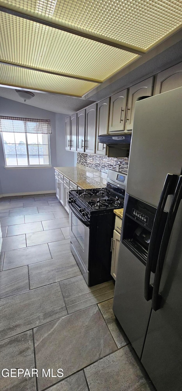 kitchen with decorative backsplash, appliances with stainless steel finishes, and exhaust hood