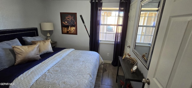 bedroom featuring baseboards and wood finished floors