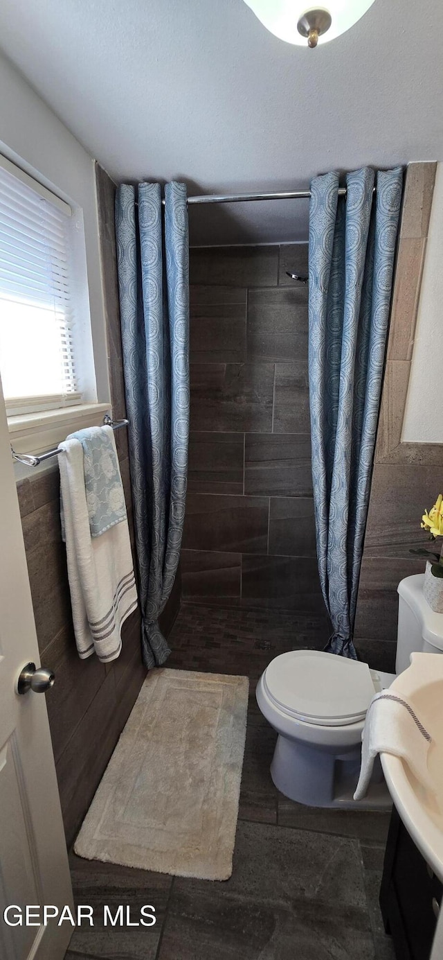 full bath with a shower stall and toilet