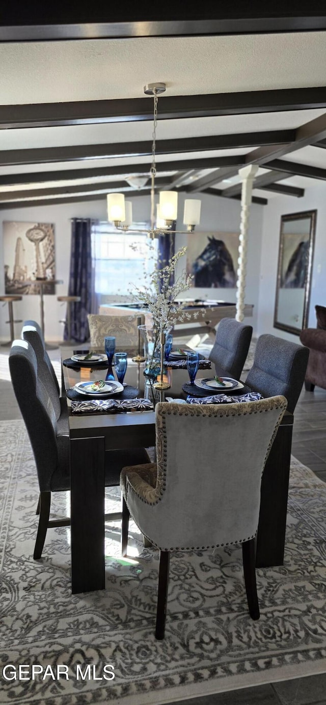 dining area with an inviting chandelier and beam ceiling