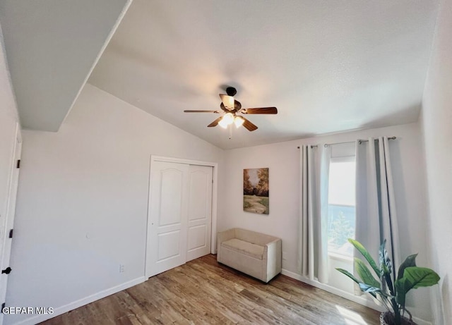 unfurnished room with lofted ceiling, light wood-type flooring, and ceiling fan