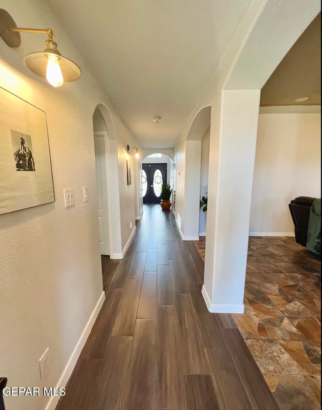 hallway with dark hardwood / wood-style floors