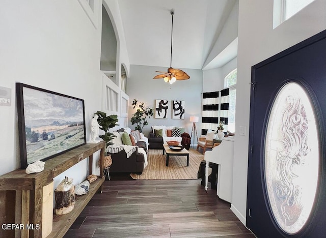 foyer with ceiling fan, high vaulted ceiling, and dark hardwood / wood-style flooring