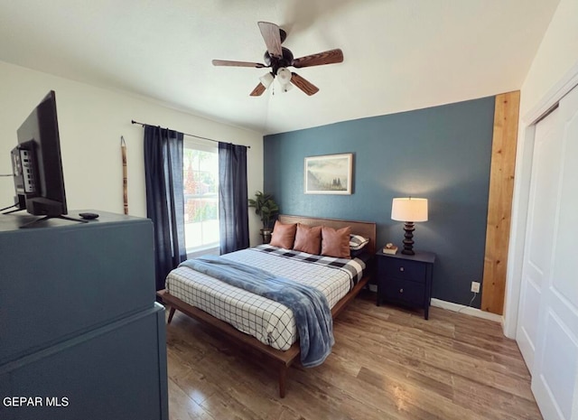 bedroom featuring a closet, hardwood / wood-style floors, and ceiling fan