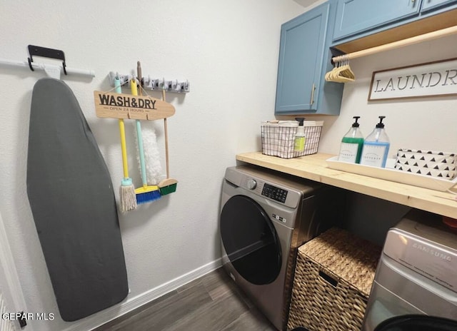 washroom featuring washer / clothes dryer, cabinets, and dark hardwood / wood-style floors