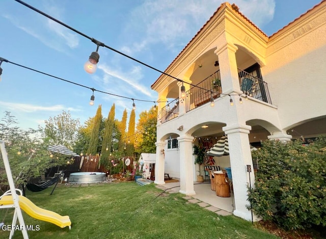 view of yard featuring a patio area and a balcony