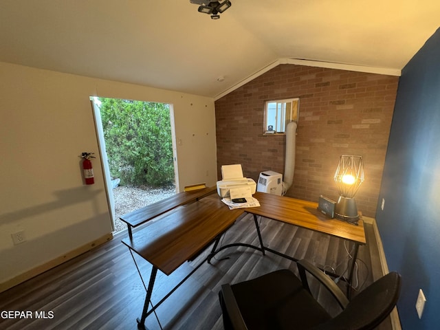 office area with lofted ceiling, dark hardwood / wood-style floors, and brick wall