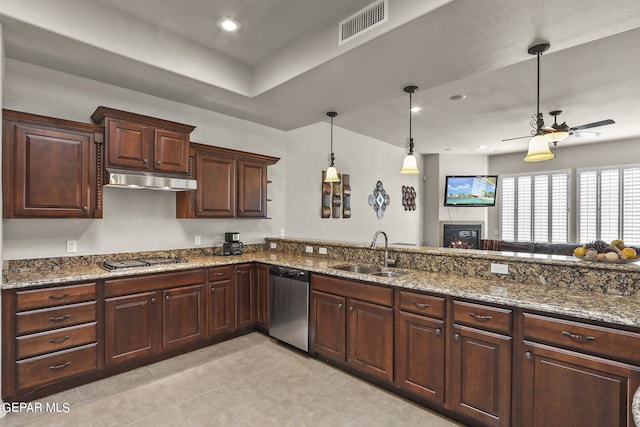 kitchen featuring stainless steel appliances, ceiling fan, sink, decorative light fixtures, and stone countertops