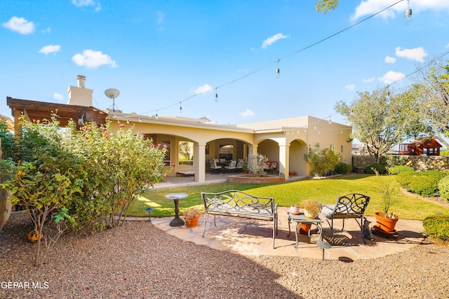 rear view of house featuring a patio and a yard