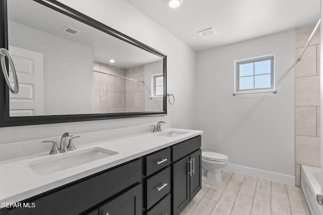 full bathroom with vanity, toilet, and tiled shower / bath