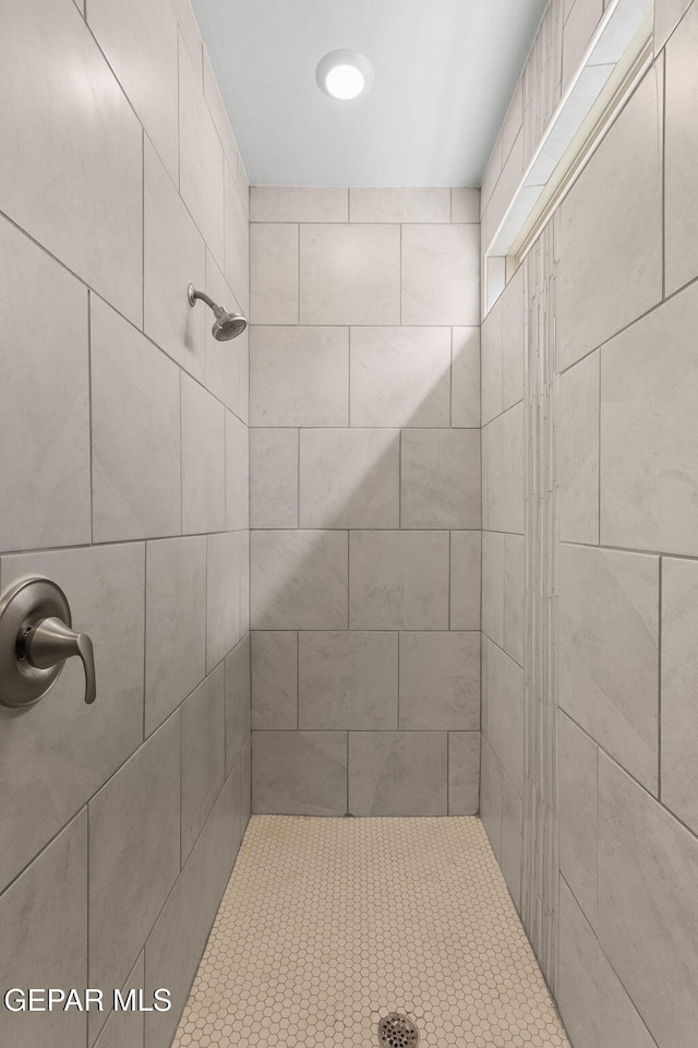 bathroom with a tile shower