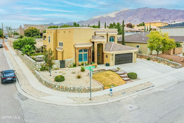 view of front facade with a mountain view and a garage