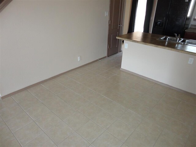 interior space with sink and light tile patterned floors