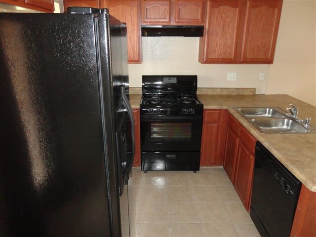 kitchen with kitchen peninsula, black appliances, sink, and light tile patterned floors