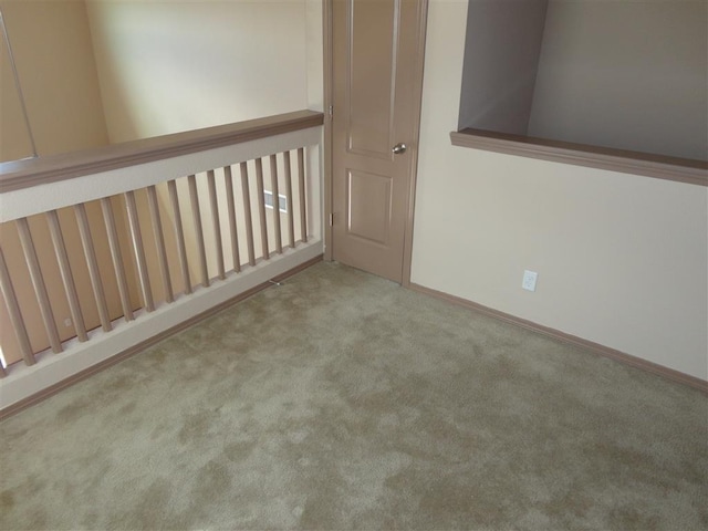 spare room featuring light colored carpet