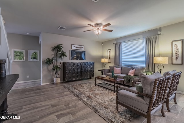 living room featuring wood-type flooring and ceiling fan