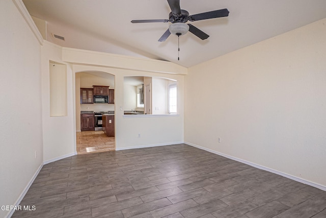 unfurnished living room with lofted ceiling, hardwood / wood-style flooring, and ceiling fan