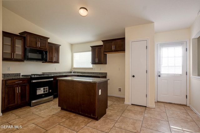 kitchen featuring stainless steel range, plenty of natural light, sink, and a center island