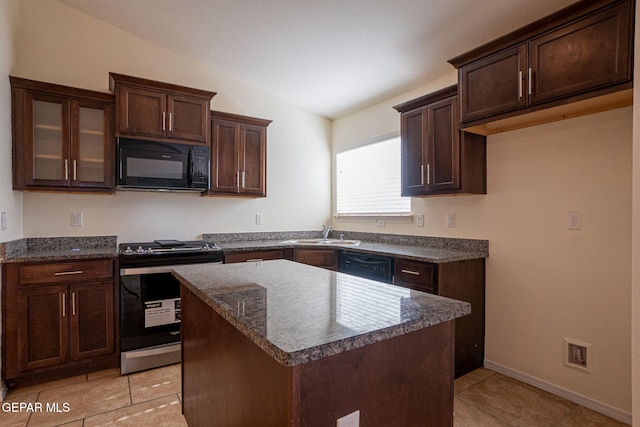 kitchen with a center island, vaulted ceiling, black appliances, sink, and dark stone countertops