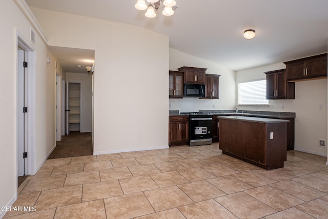 kitchen featuring dark brown cabinetry, an inviting chandelier, stainless steel range, a center island, and vaulted ceiling