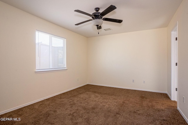 carpeted spare room with ceiling fan