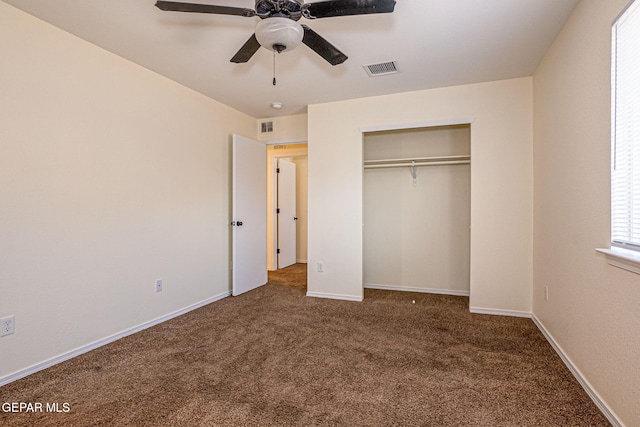 unfurnished bedroom featuring a closet, dark carpet, and ceiling fan