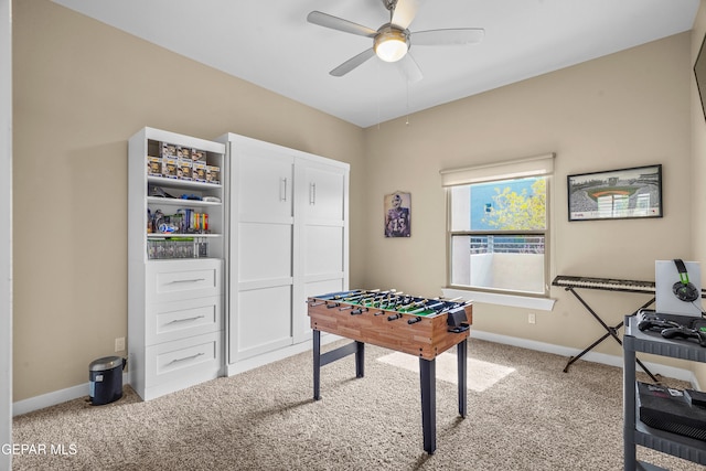 rec room with carpet floors and ceiling fan